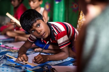 Rohingya children participate in a DFID-funded education programme in Kutupalong refugee camp in Bangladesh. UNHCR/Antoine Tardy
