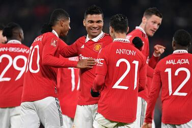 Manchester United's Brazilian midfielder Casemiro (C) celebrates with teammates after scoring their second goal during the English FA Cup fourth round football match between Manchester United and Reading at Old Trafford in Manchester, north west England, on January 28, 2023.  (Photo by Oli SCARFF / AFP) / RESTRICTED TO EDITORIAL USE.  No use with unauthorized audio, video, data, fixture lists, club/league logos or 'live' services.  Online in-match use limited to 120 images.  An additional 40 images may be used in extra time.  No video emulation.  Social media in-match use limited to 120 images.  An additional 40 images may be used in extra time.  No use in betting publications, games or single club/league/player publications.   /  