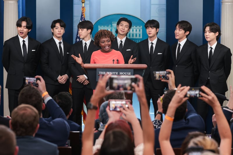 Members of BTS join Karine Jean-Pierre, White House press secretary, centre, during a news conference at the White House in Washington DC on May 31, 2022. Photo: Oliver Contreras / Sipa / Bloomberg 