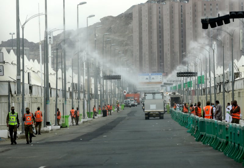 Water is sprayed to bring down the temperature at the tent city in Mina last year. AP