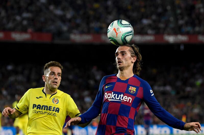 Barcelona's French forward Antoine Griezmann heads the ball next to Villarreal's Spanish midfielder Ruben Pena. AFP
