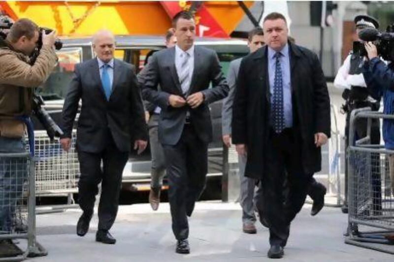 John Terry, centre, arrives at Westminster Magistrates court for the final day on his hearing of racial abuse charges.