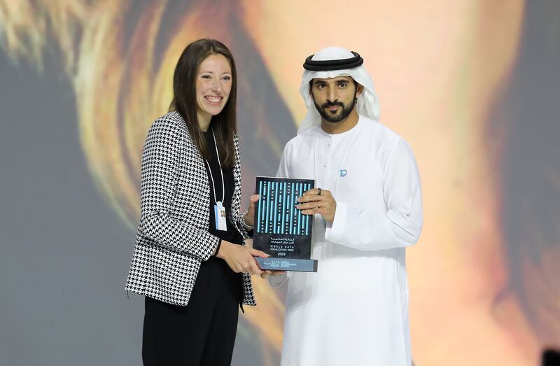 Sheikh Hamdan bin Mohammed, Crown Prince of Dubai, presents the World Data Visualisation Award to Lindsey Poulter. Pawan Singh / The National