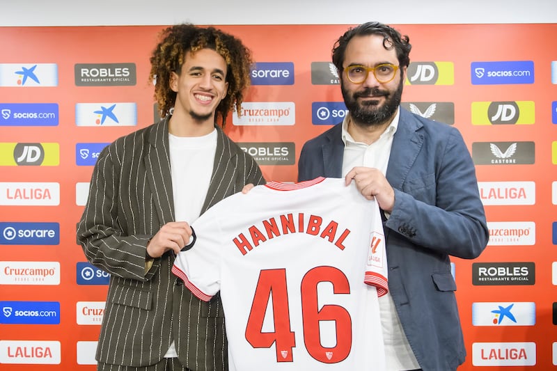Hannibal Mejbri, left, alongside Sevilla sports director Victor Orta as the midfielder is officially unveiled as a Sevilla player.   EPA