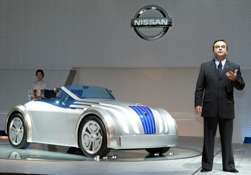 Mr Ghosn poses in front of the Jikoo concept car at the 2003 Tokyo Motor Show. Getty Images