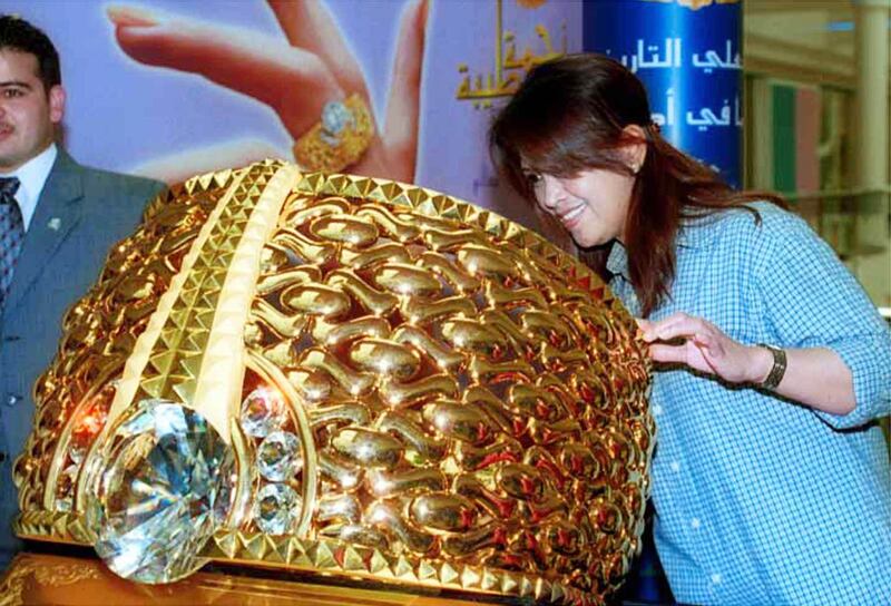 A woman looks at a 62kg gold ring, named Najmat Taiba, on display at the BurJuman shopping mall in Dubai on August 22, 2000.