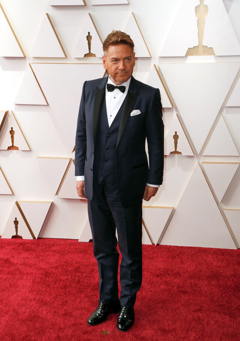 Oscar winner Sir Kenneth Branagh wears a navy three-piece suit. EPA