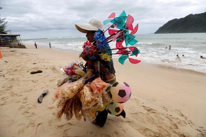 A vendor walks on a nearly empty beach during Eid Al Fitr holidays amid the coronavirus pandemic in Ule Lhuee beach, Banda Aceh, Indonesia. EPA