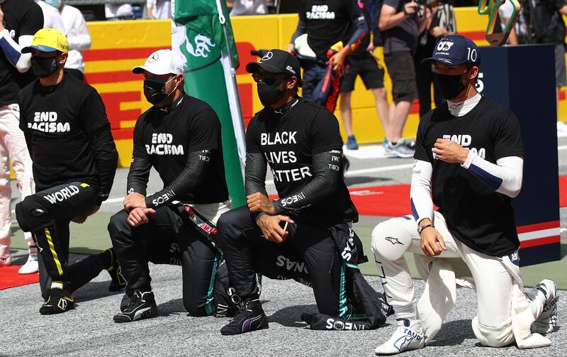 Lewis Hamilton, centre, and fellow F1 drivers take a knee and wear anti-racism T-shirts before the Styrian Grand Prix. AFP