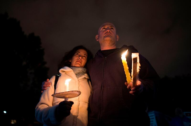 People come together for a candlelight vigil, in remembrance of those who died earlier in the day during a shooting at the Tree of Life Synagogue. AFP