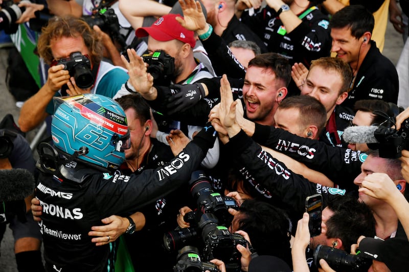 George Russell celebrates with his Mercedes team after finishing in pole position for the Brazilian Grand Prix. Reuters