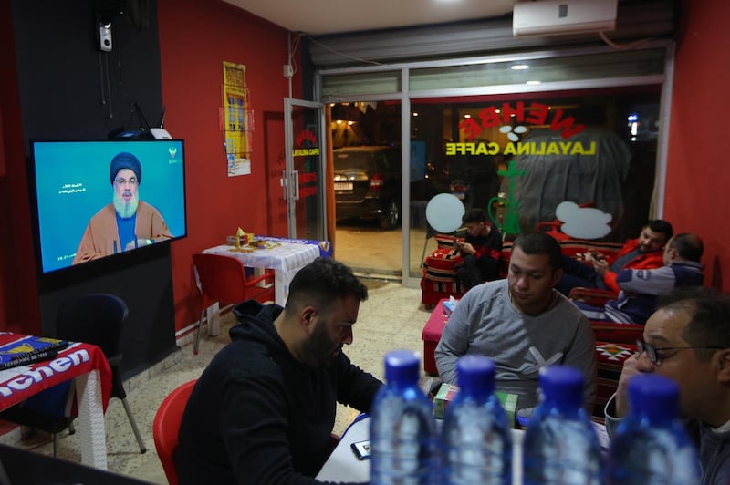 epa07343521 Lebanese citizens listen to Secretary General of Hezbollah, Sayyed Hassan Nasrallah during his speaks on Al-Manar TV screen where he spoke about the latest political developments in Lebanon and the situation after new government formed with three Hezbollah ministers, at a coffeshop in Beirut, Lebanon, 04 February 2019.  EPA/NABIL MOUNZER