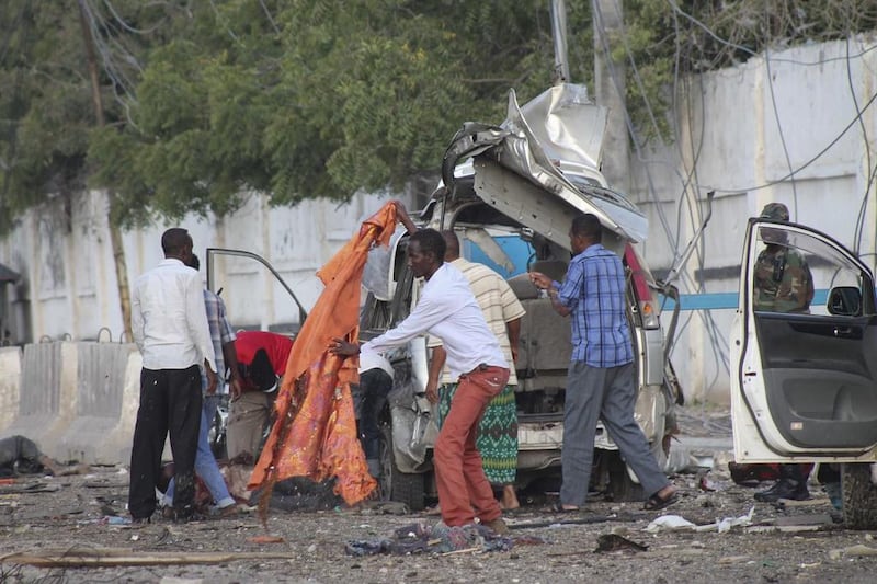 People gather around the scene of a car bomb explosion in front of the Sahafi Hotel in Mogadishu, Somalia, on November 1, 2015. Said Yusuf Warsame / EPA