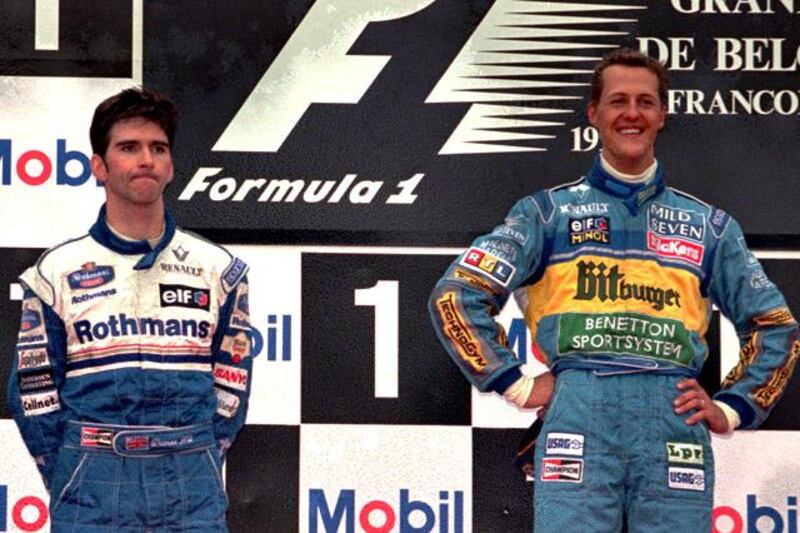 Defending champion Michael Schumacher of Germany, right, is all smiles celebrating his victory in the Belgium F1  Grand Prix next to second-placed Damon Hill  on the podium in Spa-Francorchamps Sunday August 27, 1995.(AP Photo/Dusan Vranic)