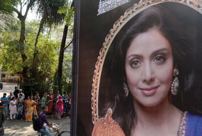 A picture of Bollywood actress Sridevi Kapoor is seen put up outside her residence in Mumbai on February 26, 2018, following her death. 
Heartbroken fans on February 26 awaited the arrival of the body of Bollywood superstar Sridevi Kapoor as tributes poured in for the actress who died in Dubai of a heart attack aged just 54. / AFP PHOTO / PUNIT PARANJPE