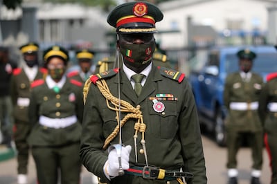 epa08939157 A military legion member wears a face mask as he stands in line during a military parade for the fallen heroes at the Tafawa Balewa military arcade in Lagos, Nigeria, 15 January 2021. The Nigerian military celebrates fallen heroes in the ceremony that includes laying of wreaths, a military parade, and gun salutes.  EPA/AKINTUNDE AKINLEYE