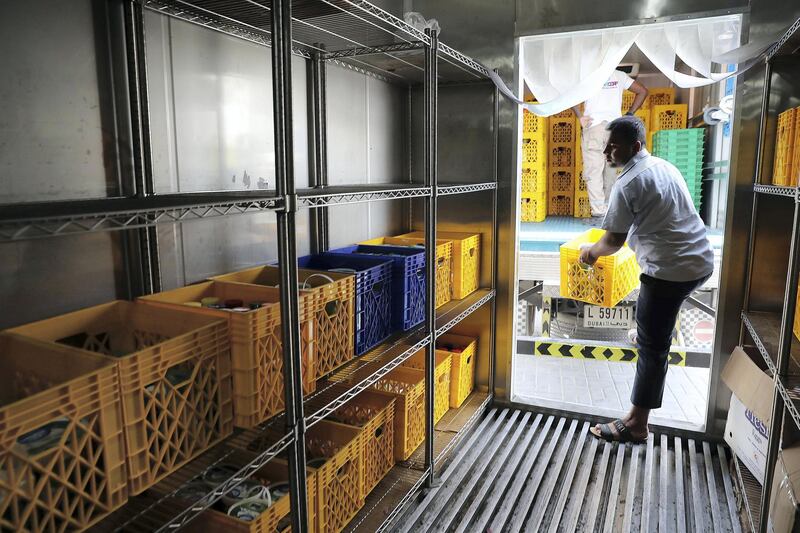 DUBAI , UNITED ARAB EMIRATES , JULY 11 – 2018 :- Workers unloading the food collection truck at the UAE Food Bank in Al Quoz with food stuff collected from different supermarkets , hotels and bakeries in Dubai.  ( Pawan Singh / The National )  For News. Story by Patrick Ryan