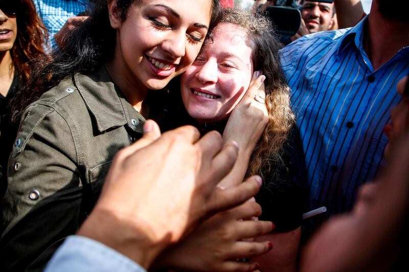 Palestinian activist and campaigner Ahed Tamimi celebrates with supporters after leaving prison  AFP