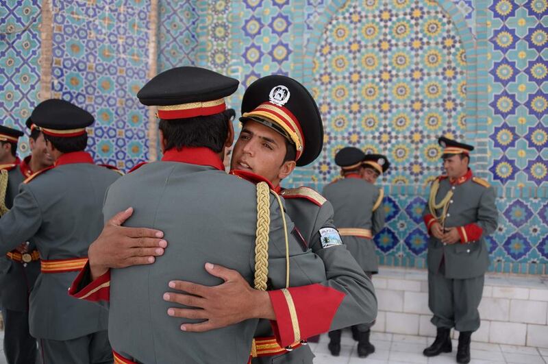 Members of an Afghan guard of honour greet each other after offering Eid-al-Adha prayers at the Hazrat-i- Ali shrine in Mazar-i Sharif.  Farshad Usyan / AFP