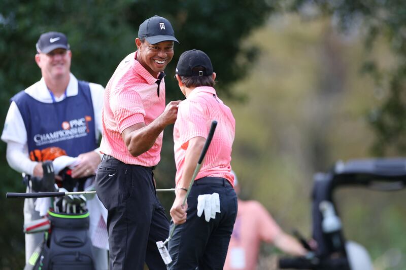 Tiger Woods and Charlie Woods celebrate on the ninth green during the first round of the PNC Championship. Getty