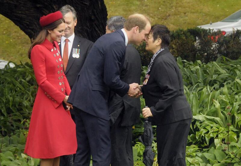 Prince William receiving a "hongi", a traditional Maori greeting, by a Maori elder as his wife Catherine looks on, during a welcoming at Government House in Wellington. AFP