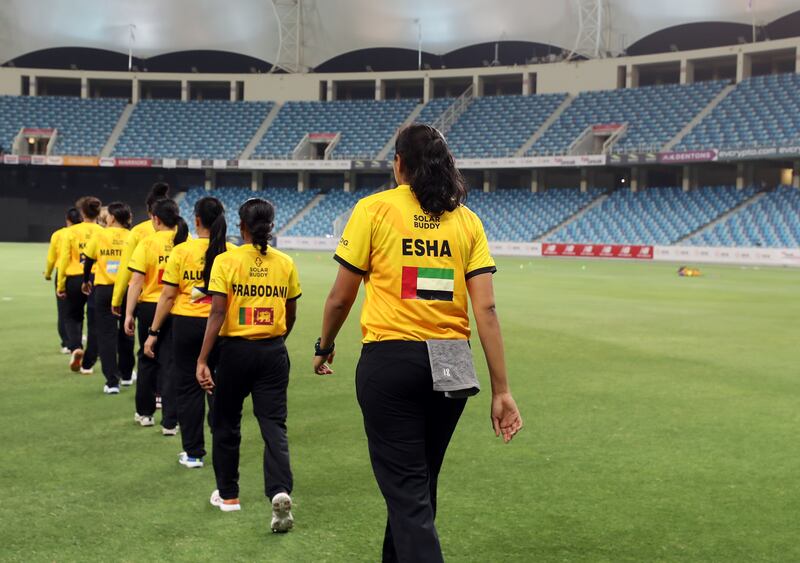 Warriors players including the UAE's Esha Oza make their way on to the pitch at the Dubai International Stadium.
