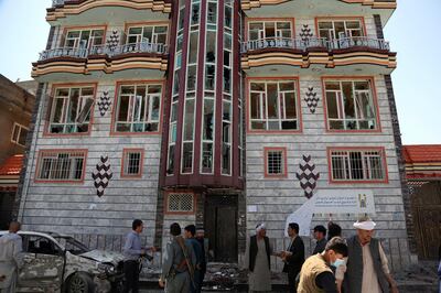 People gather outside a voter registration center which was attacked by a suicide bomber in Kabul, Afghanistan, Sunday, April 22, 2018.  Gen. Daud Amin, the Kabul police chief, said the suicide bomber targeted civilians who had gathered to receive national identification cards. (AP Photo/ Rahmat Gul)