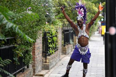 A reveller dressed in carnival costume dances after the normal Notting Hill Carnival festivities was cancelled amid the coronavirus disease (COVID-19) outbreak, in London, Britain, August 31, 2020. REUTERS/Toby Melville