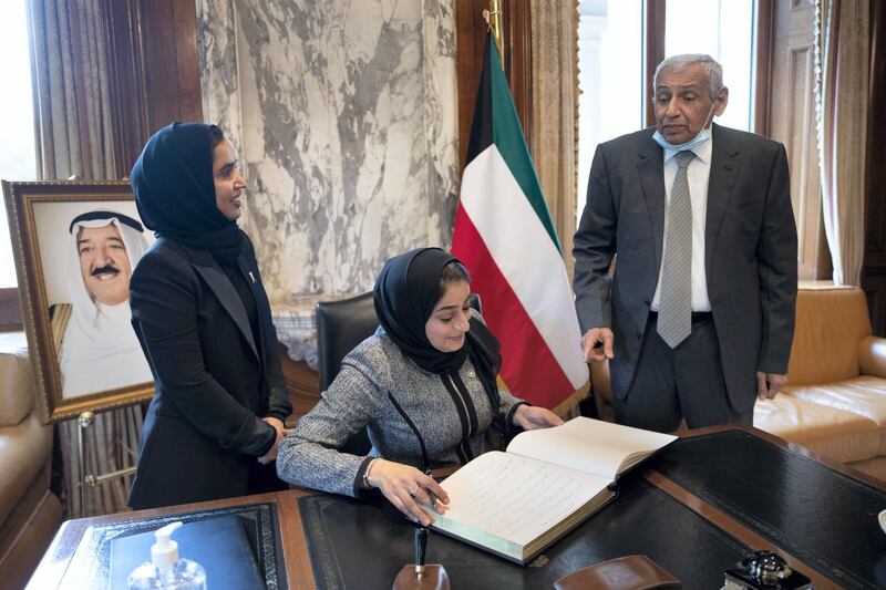 LONDON 1st October 2020. Rua AlZadjali (centre) and Amal Ali from the Oman Embassy in London sign a book of condolence at the Kuwait Embassy in London with the Kuwait Ambassador Khaled Al-Duwaisan (right)  following the death of the Emir of Kuwait. Stephen Lock for the National 