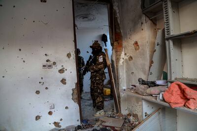 Taliban inspect the scene of an operation against the ISIS militants at a hideout on the outskirts of Kabul. EPA