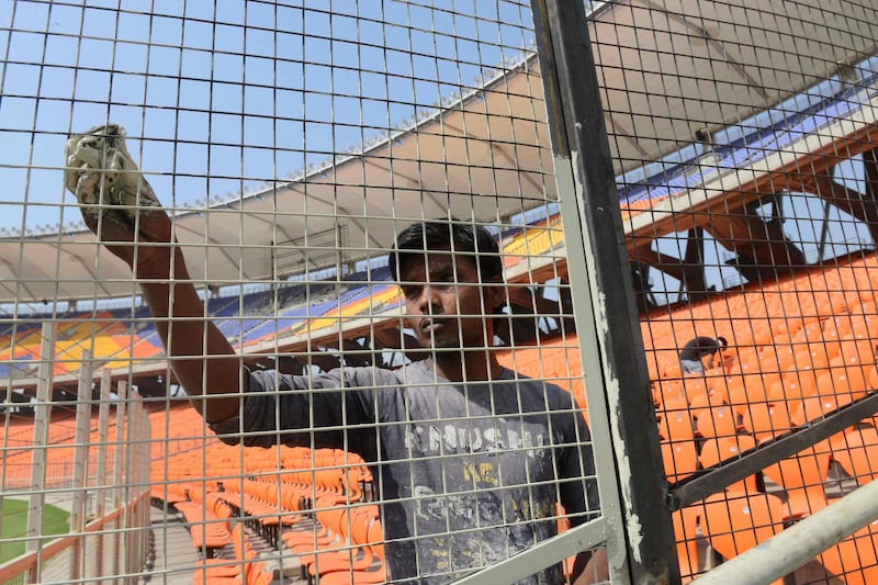 A worker cleans the Sardar Patel Stadium, the world's biggest cricket stadium, ahead of the third Test. AFP