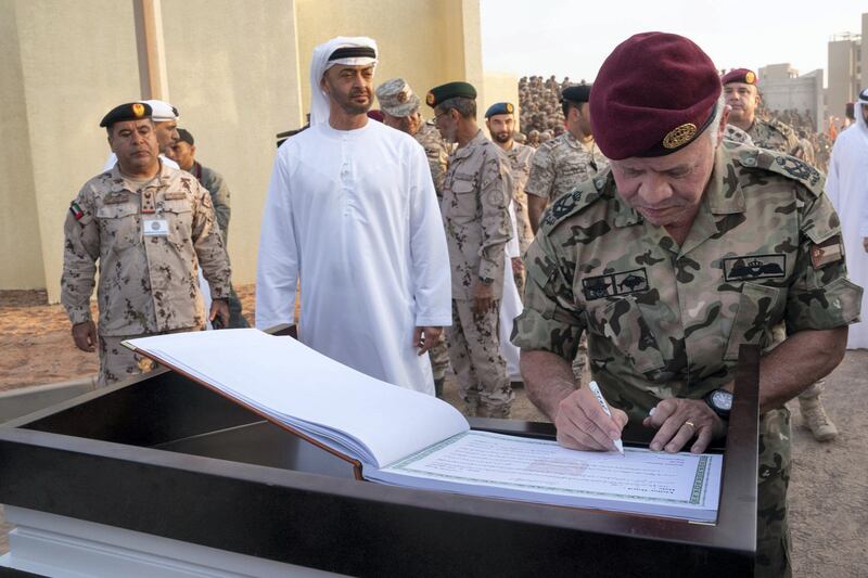 AL DHAFRA REGION, ABU DHABI, UNITED ARAB EMIRATES - June 26, 2019: HM King Abdullah II, King of Jordan (R), signs the guest book, after attending the UAE and Jordan joint military drill, Titled ‘Bonds of Strength’, at Al Hamra Camp. Seen with HH Sheikh Mohamed bin Zayed Al Nahyan, Crown Prince of Abu Dhabi and Deputy Supreme Commander of the UAE Armed Forces (2nd L).

( Mohamed Al Hammadi / Ministry of Presidential Affairs )
---