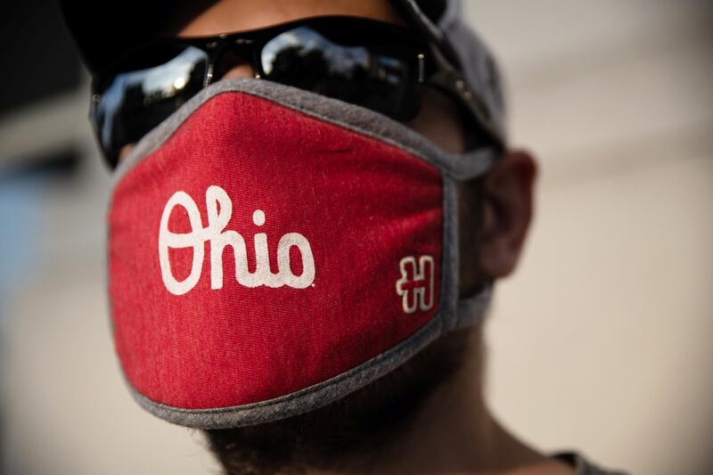 An Ohio State football fan sports a 'Script Ohio' face mask outside the Ohio State university football facilities as the Big Ten postpones their 2020-21 fall sports season, citing coronavirus concerns in Columbus, Ohio, US. Reuters