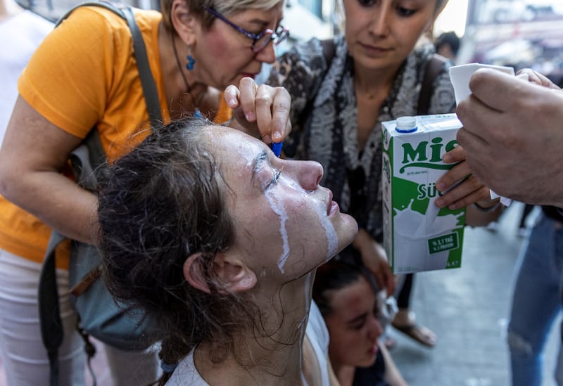 People pour milk into the eyes of a woman affected by tear gas as protesters clash with police while commemorating the ninth anniversary of the Gezi Park protests in Istanbul in 2013. Reuters
