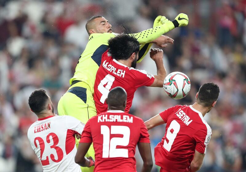 Palestine's Mohammed Saleh in action with Jordan's Amer Shafi. Reuters