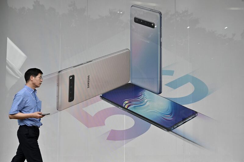 A man walks past an advertisement for the Samsung Galaxy S10 5G smartphone in Seoul on July 31, 2019. The world's biggest smartphone and memory chip maker Samsung Electronics on July 31, reported second quarter net profits slumping by more than half in the face of a weakening chip market, and as a trade row builds between Seoul and Tokyo. / AFP / Jung Yeon-je
