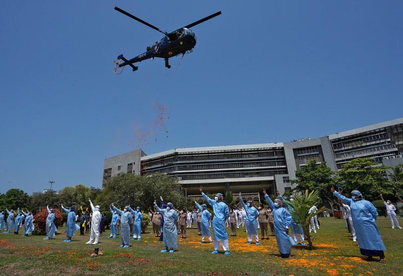An Indian Navy Chetak helicopter drops flower petals on the staff of INHS Asvini hospital in Mumbai as part of nationwide tributes to frontline warriors in India's fight against the Covid-19 outbreak. Reuters