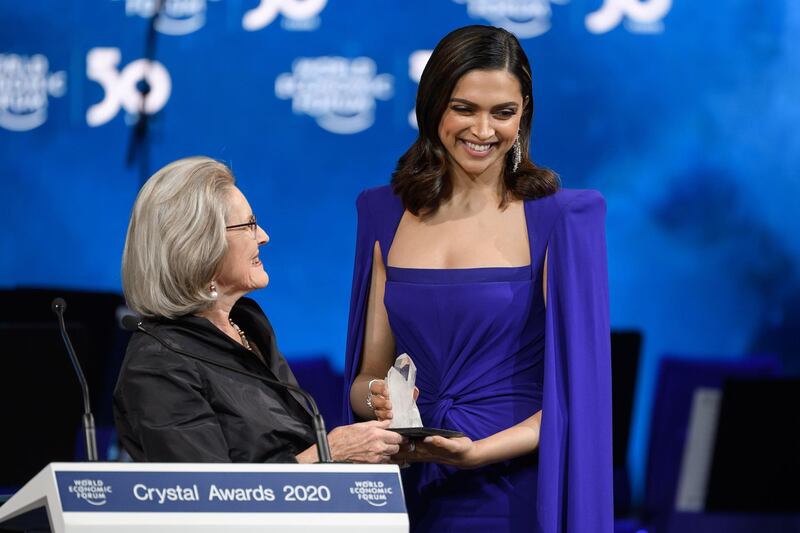 Indian actress Deepika Padukone (right) receive a trophy from Hilde Schwab, Chairwoman and Co-Founder of the World Economic Forum's World Arts Forum during the "Crystal Award" ceremony at the World Economic Forum (WEF) annual meeting in Davos.  AFP