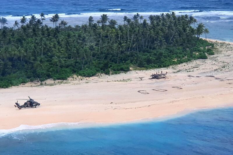 An Australian Army helicopter lands on Pikelot Island where three men were found safe and healthy after their giant SOS sign was spotted by warplanes. Australian Defence Force via AFP