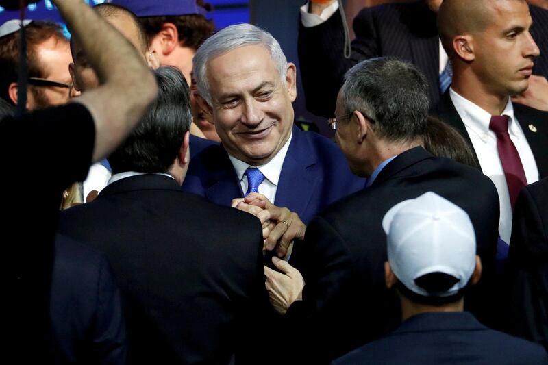 FILE PHOTO: Israeli Prime Minister Benjamin Netanyahu is greeted by supporters of his Likud party as he arrives to speak following the announcement of exit polls in Israel's parliamentary election at the party headquarters in Tel Aviv, Israel April 10, 2019. REUTERS/Ronen Zvulun/File Photo
