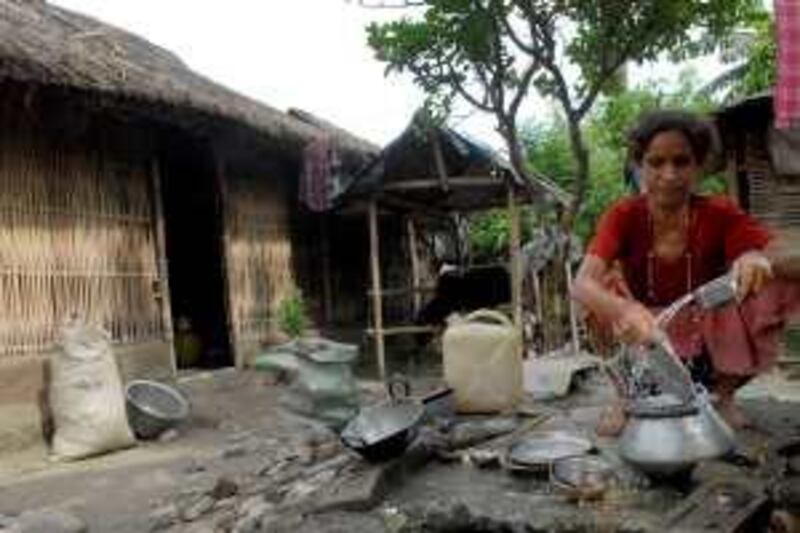 TO GO WITH NEPAL-BHUTAN-REFUGEES-SCENE by Subil Bhandari

A Bhutanese refugee cleans utensils at The Beldangi Refugee Camp, some 300kms south-east of Kathmandu on September 11, 2008.   The refugees have languished in United Nations camps in southern Nepal for nearly 20 years, and now after the United States offered to resettle at least 60,000 people, many are preparing to leave.  Around 50,000 of the refugees have signed up for international resettlement, and 5,000 have already left. AFP PHOTO/Prakash MATHEMA