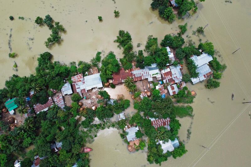 In this aerial photo inundated houses are seen in Sunamgong on July 15, 2020. AFP