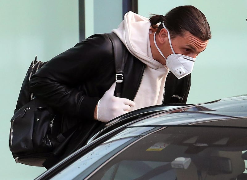 Zlatan Ibrahimovic, wearing a protective face mask, arrives at Malpensa airport in Milan. EPA