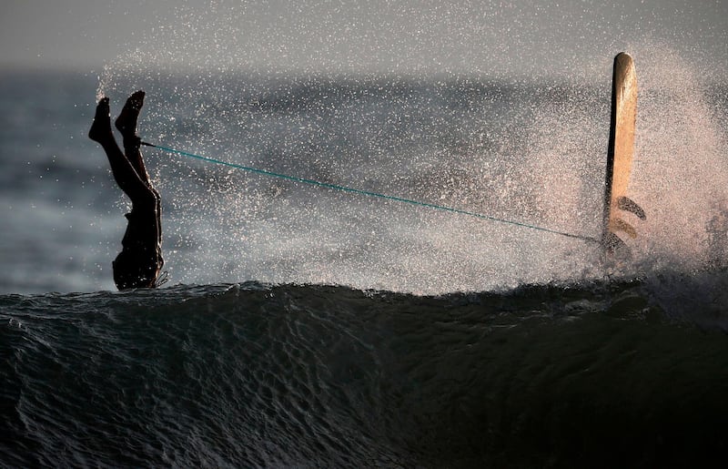 A surfer flips into the water as he crashes over the top of a wave in the ocean at Omaezaki. Japan. AFP