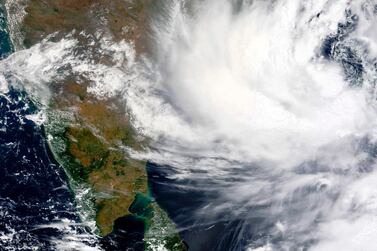 This Monday, May, 24, 2021, satellite image provided by NASA shows Cyclone Yaas approaching India's eastern coast. Yaas is expected to make landfall on Wednesday, May 26, 2021, and could pack sustained winds of up to 165 kilometers per hour (102 miles per hour), the India Meteorological Department said. It said the storm was forecast to hit the eastern states of West Bengal and Odisha, just days after a powerful storm battered the country's western coast and killed at least 140 people. (NASA Worldview, Earth Observing System Data and Information System (EOSDIS) via AP)