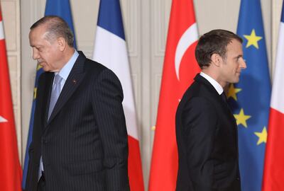 (FILES) In this file photo taken on January 5, 2018, French President Emmanuel Macron (R) and Turkish President Recep Tayyip Erdogan walk during a joint press conference at the Elysee Palace in Paris. Turkish President Recep Tayyip Erdogan on December 4, 2020, described his French counterpart Emmanuel Macron as "trouble" and said he hoped France would "get rid of him" as soon as possible, in the latest salvo in an escalating war of words between the two leaders. Turkey and France are embroiled in a series of disputes from tensions in the eastern Mediterranean to the disputed Nagorno-Karabakh region. / AFP / LUDOVIC MARIN
