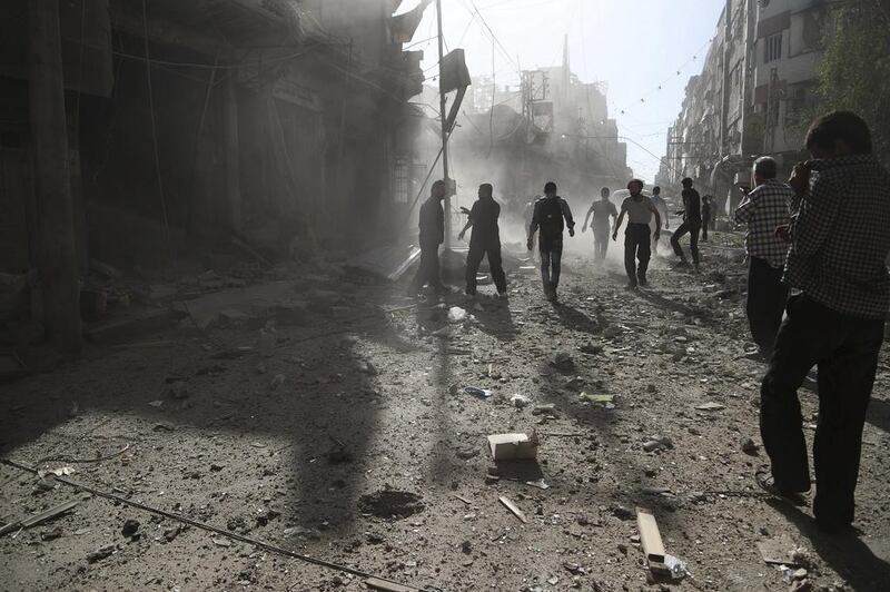 Residents of the town of Douma, eastern Ghouta of Damascus, inspect damage after an airstrike. Bassam Khabieh / Reuters