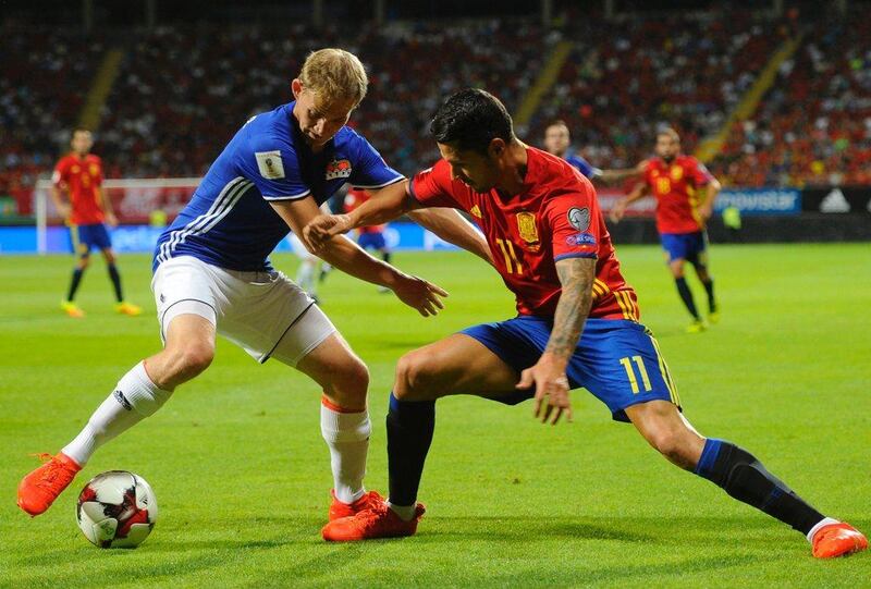 Liechtenstein defender Martin Rechsteiner, left, vies with Spain midfielder Vitolo. Miguel Riopa / AFP