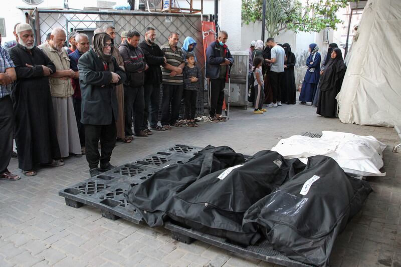 Mourners next to the bodies of Palestinians killed in an Israeli strike in southern Gaza. Reuters