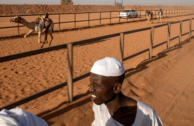 Sudanese youths watch a camel race at a track near al-Ikhlas village in the west of the city of Omdurman. The race is organised by traditionally camel-rearing tribal families from the village as a way to preserve and celebrate their heritage. AFP